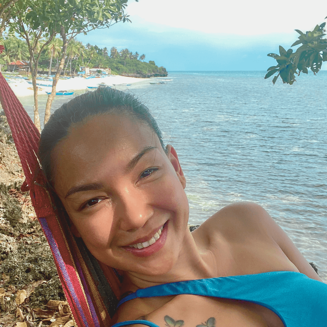 Smiling Lady on a Hammock with a beautiful serene view of the ocean and nature