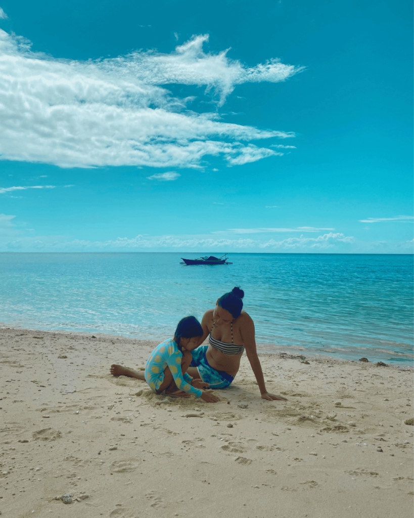 Mom with Little Daughter playing on the beach