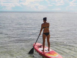 Lady on a bikini Paddle Boarding on the beach