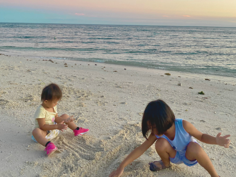 Little Girls playing at the beach during sunset