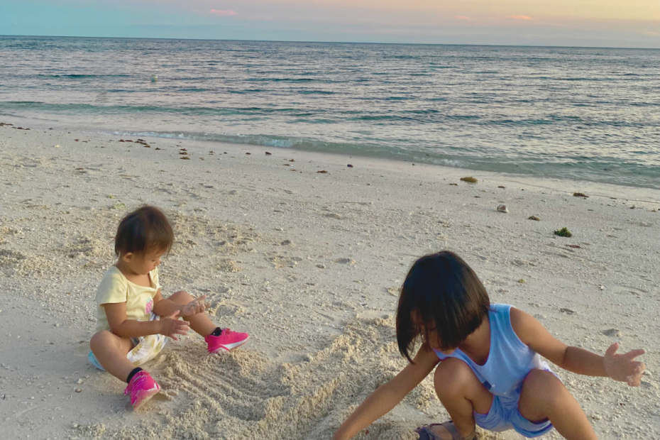 Little Girls playing at the beach during sunset