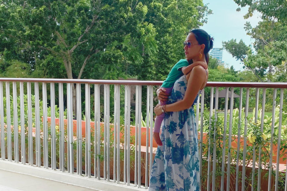 Mother holding a baby in her arms with a nature background