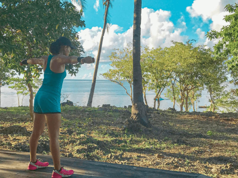 A mom working out outdoors with the view of nature and the ocean