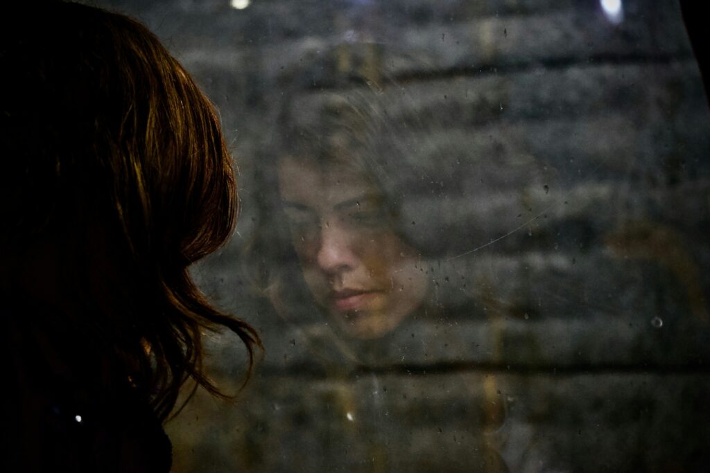 Woman reflection on the mirror going through postpartum depression 