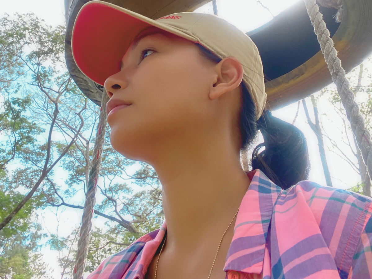 An overstimulated mom staring blankly, overwhelmed by noise and chaos, struggling to process the mental load of motherhood.