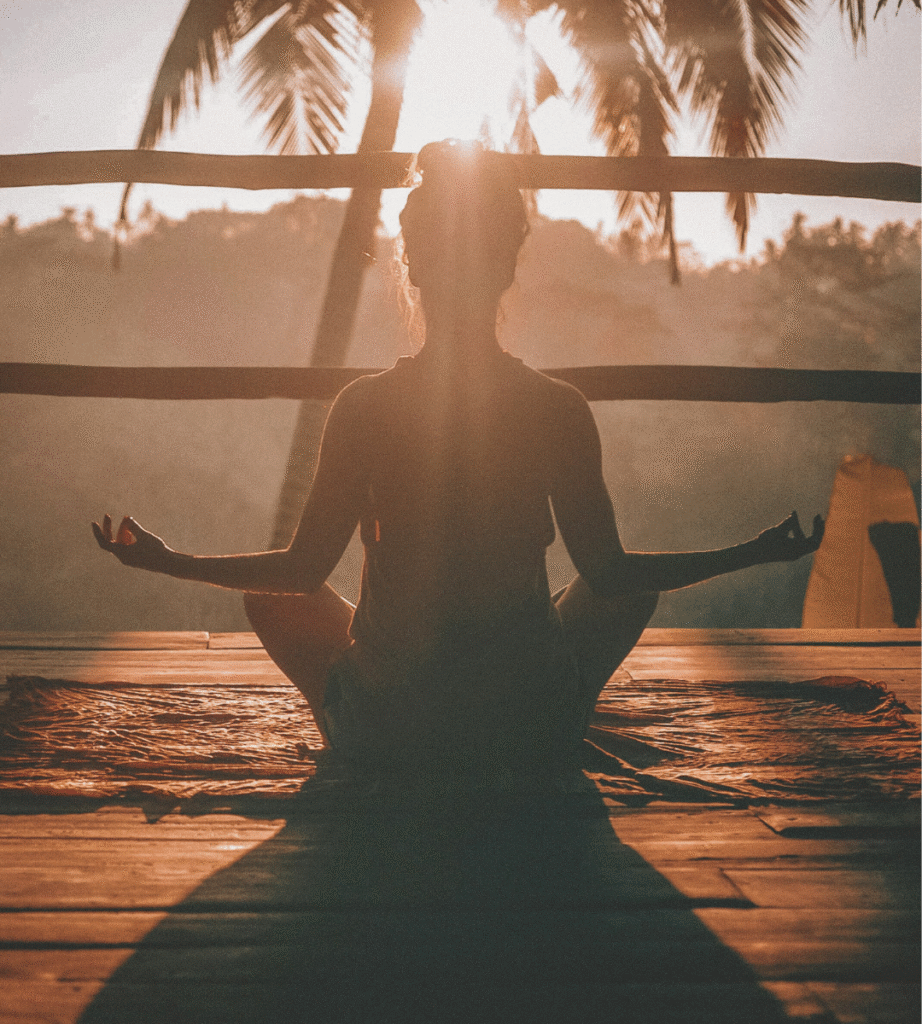 A woman doing a meditation practicing holistic self-care for moms feeling more than just mom