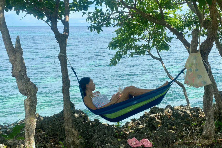 Tired mom lying on a hammock, a quiet moment capturing the feeling of losing yourself in motherhood, gazing into the distance.