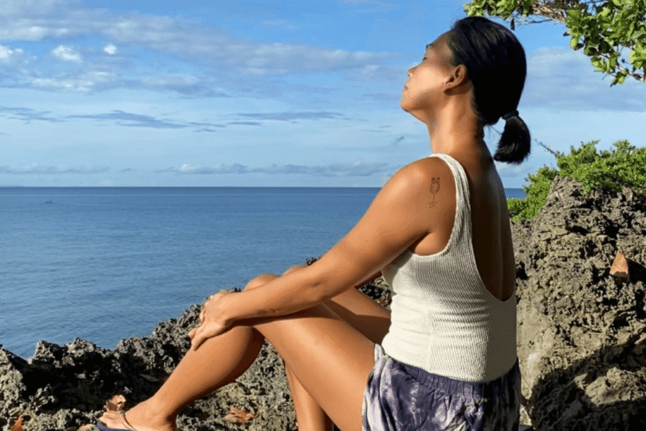 A mom spending quiet time in nature, looking calm and fulfilled after completing her morning routine easing the mental load of motherhood.