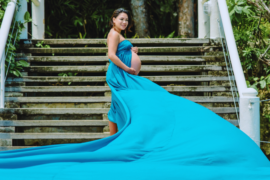 Pregnant woman gently holding her belly, reflecting on preparing for childbirth with self-care and emotional readiness.