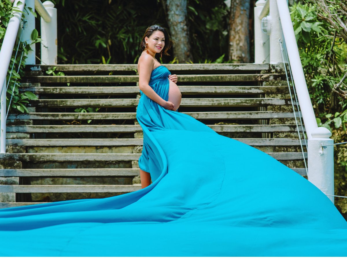 Pregnant woman gently holding her belly, reflecting on preparing for childbirth with self-care and emotional readiness.