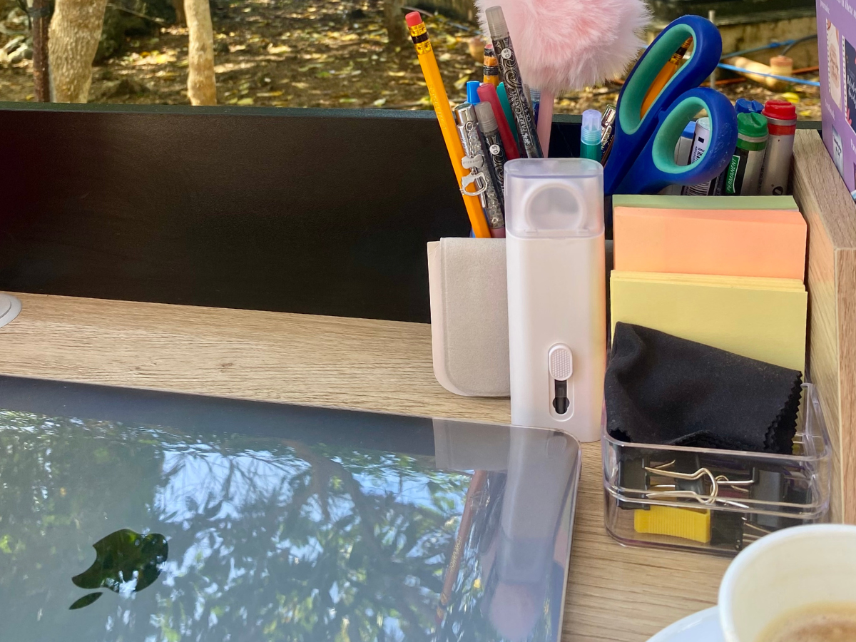 Outdoor workspace with a laptop on a table by the ocean, symbolizing freedom and balance after giving up your career to be a stay-at-home mom.