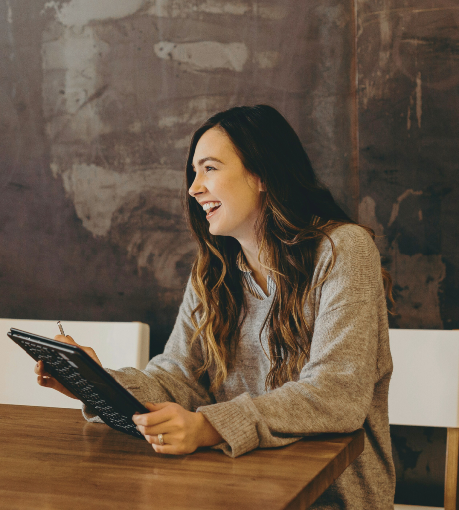 A happy mom holding her iPad chasing her dreams, feeling more than just mom