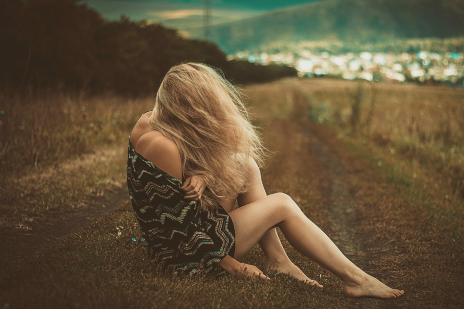 a woman sitting on the field healing from a toxic relationship