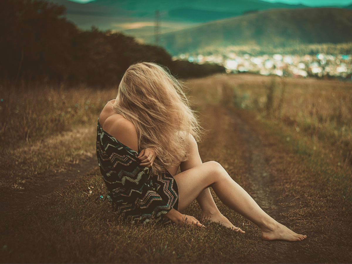 a woman sitting on the field healing from a toxic relationship