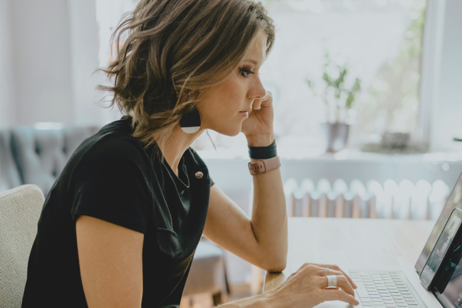 A mom working remotely on a laptop while learning how to rebuild confidence after a career break