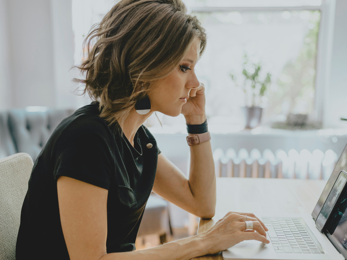 A mom working remotely on a laptop while learning how to rebuild confidence after a career break
